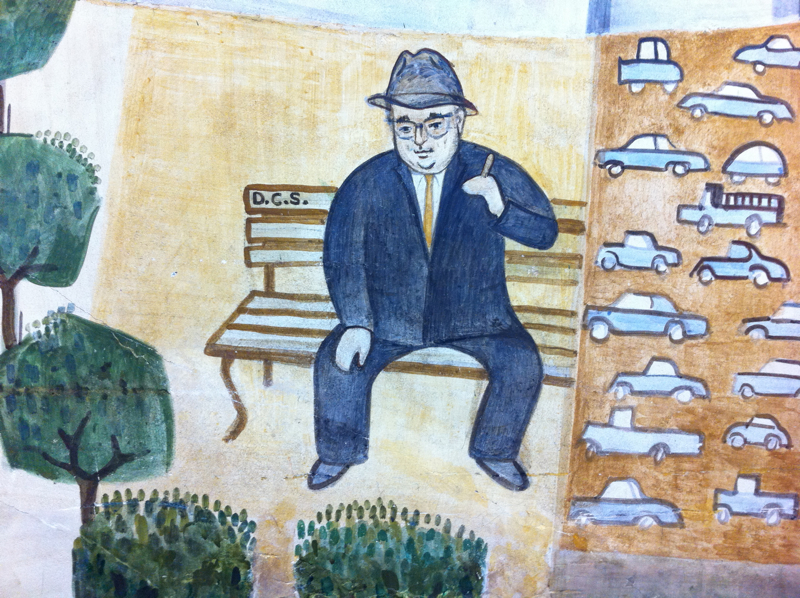 self-portrait in a mural at a Citibank office in San Francisco, a man in a blue suit and a gray hat sitting on a park bench with a cigarette in his hand