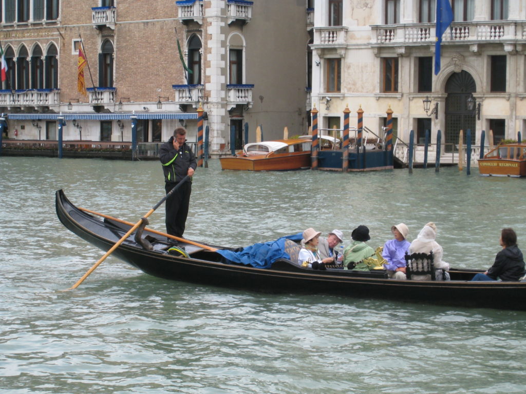 gondolier using cellphone