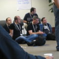 Jono Bacon and others seated on a conference room floor