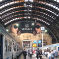 Milan Central Station, view from platform to main station with large Versace ad near the ceiling