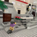 a minifig's point of view of my medieval village build, showing two minifig tourists taking photos